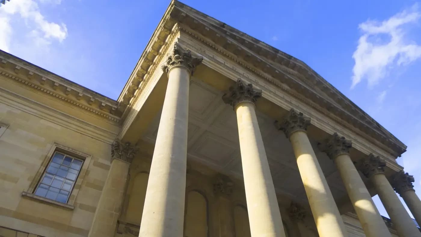 Exterior view of the Metropolitan Tabernacle portico with its Corinthian columns against a blue sky