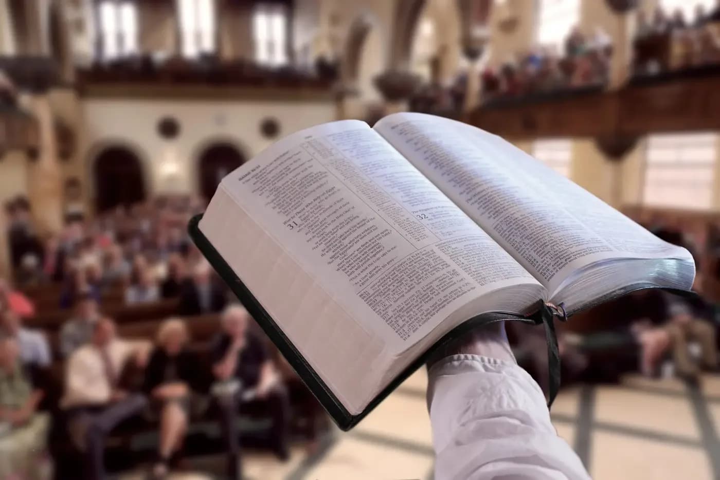 Interior of Tenth Presbyterian Church sanctuary with congregation and open Bible held aloft