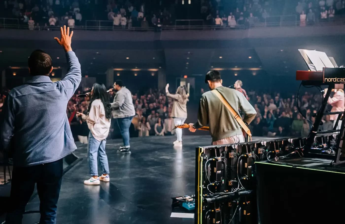 Worship team leading music on stage in front of a large congregation at Southeast Christian Church