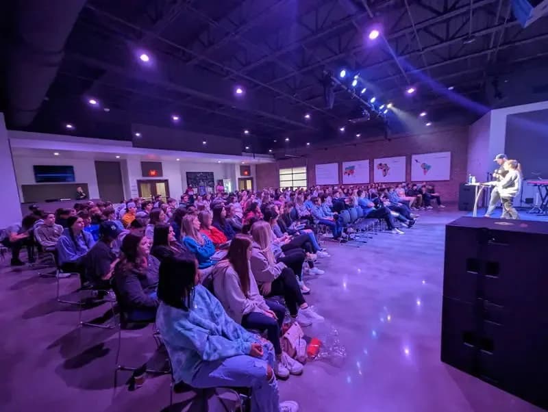 Interior worship space at The Summit Church filled with a large congregation seated facing the stage