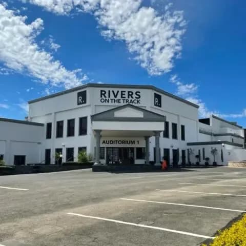 Exterior of Rivers on the Track church building with parking lot
