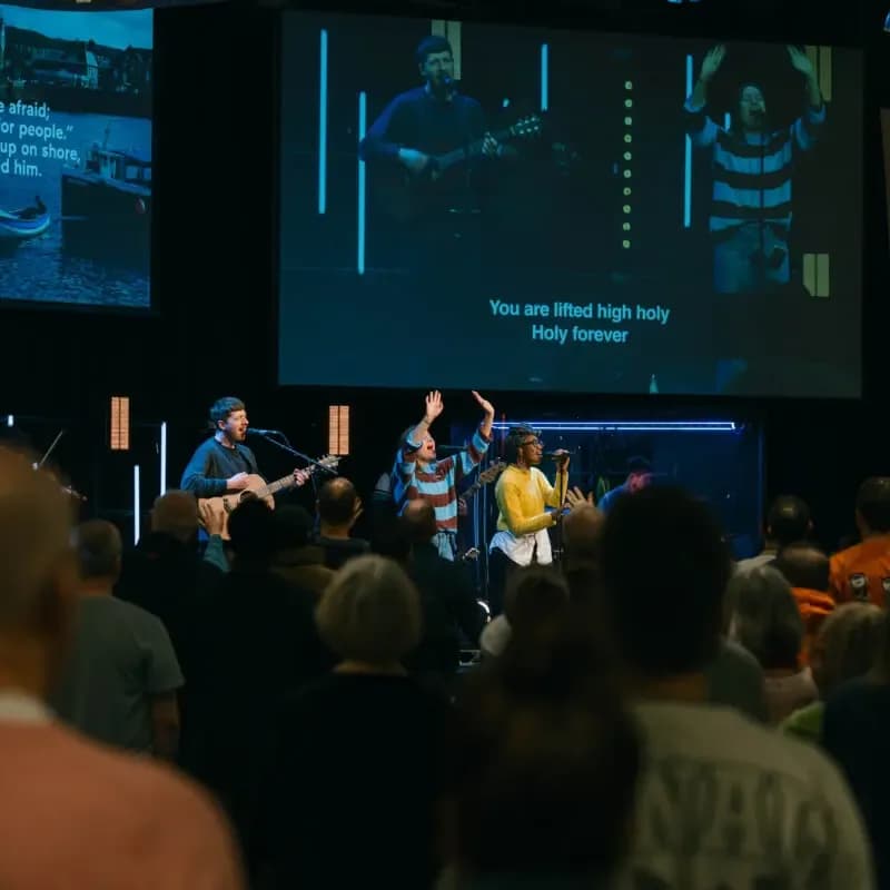 Worship service at Trent Vineyard with a band leading a congregation in song