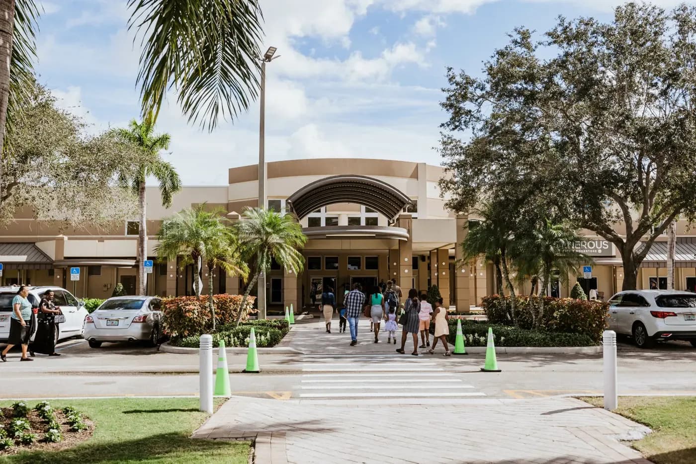 Exterior entrance of Calvary Chapel Fort Lauderdale with people walking toward the main doors