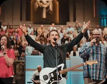 Worship service with musicians leading and a congregation gathered in the sanctuary at Idlewild Baptist Church