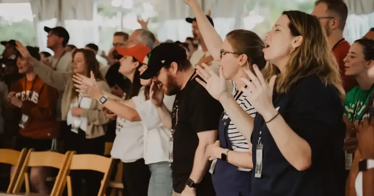 Congregation worshipping with raised hands during a service at The Austin Stone Community Church